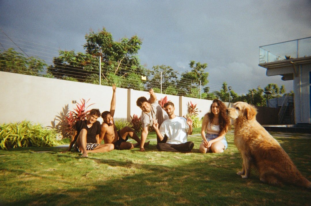 A family sitting outdoors with a dog
