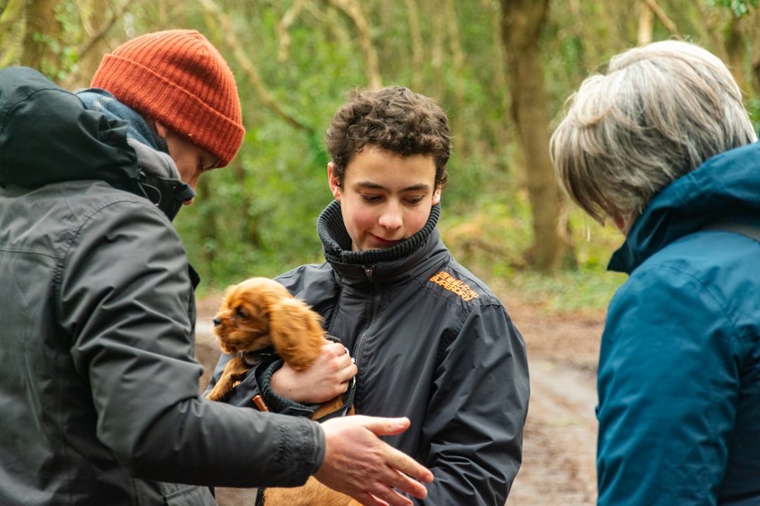 A family meeting and holding a new puppy outdoors