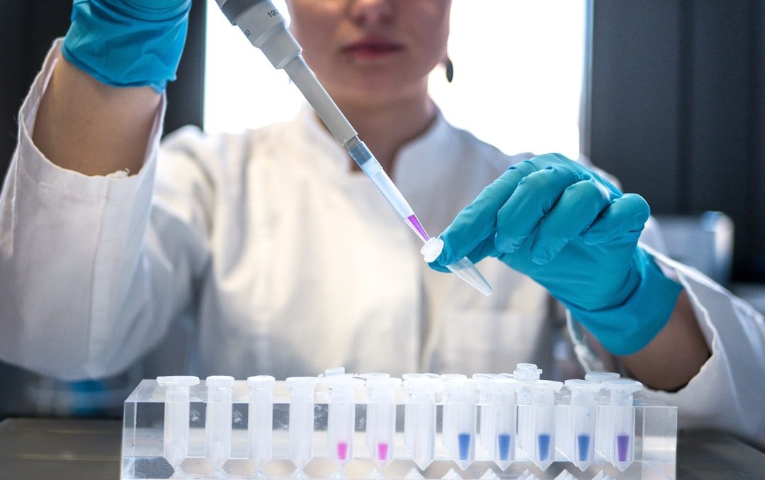 Laboratory technician processing a genetic sample with a pipette