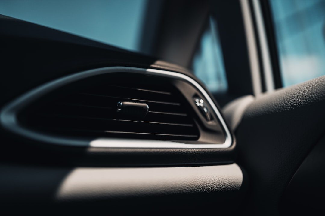 Empty parked car interior with sunlight streaming through the windshield